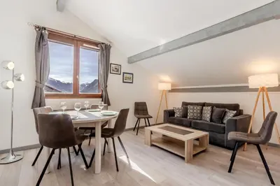 a living room with a table and a couch at Appt Donna - Chamonix Centre in Chamonix-Mont-Blanc
