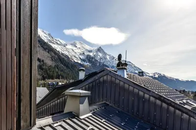 a view of the mountains from the roof of a house at Appt Donna - Chamonix Centre in Chamonix-Mont-Blanc