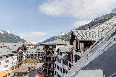 a view of a city with buildings and mountains at Triplex - Hypercentre - Balcon avec vue montagnes in Chamonix-Mont-Blanc