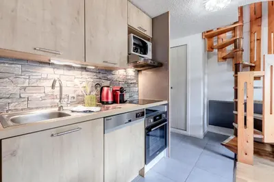 a kitchen with a sink and a stove at Triplex - Hypercentre - Balcon avec vue montagnes in Chamonix-Mont-Blanc