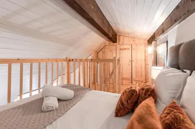 a bedroom with a bed in a wooden room at Triplex - Hypercentre - Balcon avec vue montagnes in Chamonix-Mont-Blanc
