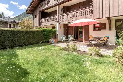 a living room with a table and a couch at Les jardins de Taconnaz - Les Houches in Les Houches