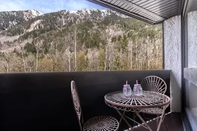 a table and chairs on a balcony with a view at Sun Valley 1 - calme - Acces bus - Proche lac in Chamonix-Mont-Blanc
