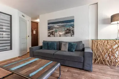 a living room with a couch and a table at Sun Valley 1 - calme - Acces bus - Proche lac in Chamonix-Mont-Blanc