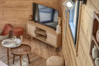 a view of a living room with a tv in a tiny house at Chalet Marie situé 25km Chamonix in Saint-Gervais-les-Bains