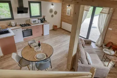a kitchen and living room with a table and a couch at Chalet Marie situé 25km Chamonix in Saint-Gervais-les-Bains