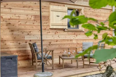 a wooden patio with a table and chairs at Chalet Marie situé 25km Chamonix in Saint-Gervais-les-Bains