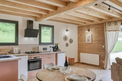 a kitchen and dining room with a table at Chalet Marie situé 25km Chamonix in Saint-Gervais-les-Bains