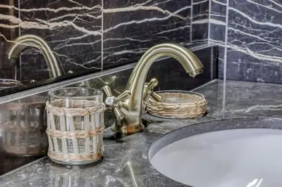 a bathroom counter with two faucets and a sink at Chalet Marie situé 25km Chamonix in Saint-Gervais-les-Bains