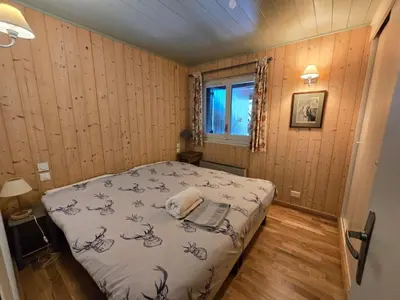 a bedroom with a bed with a laptop on it at Alpine Escape Mont Blanc at Your Window in Chamonix-Mont-Blanc