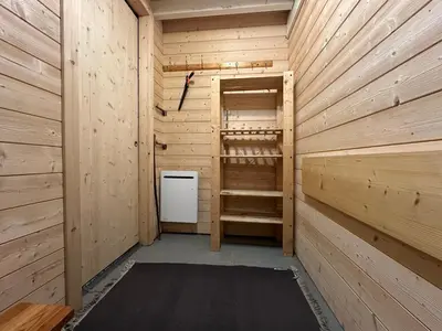 a wooden sauna with a refrigerator and a stove at Alpine Escape Mont Blanc at Your Window in Chamonix-Mont-Blanc