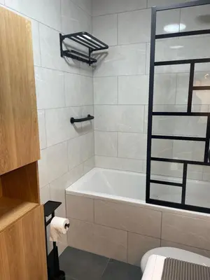 a bathroom with a bath tub and a toilet at Magnifique Studio Plein centre vue panoramique in Chamonix-Mont-Blanc