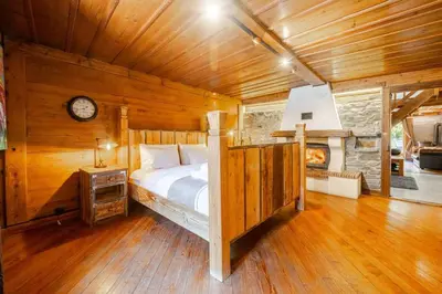 a bedroom with a bed and a clock on the wall at Marmotte Mountain Manor in Chamonix-Mont-Blanc