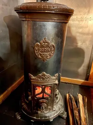 a large metal vase sitting on top of a table at Marmotte Mountain Manor in Chamonix-Mont-Blanc