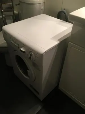 a washing machine in a bathroom with a sink at Plein centre vue panoramique exceptionnelle Sud très grand studio in Chamonix-Mont-Blanc