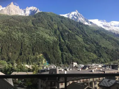 a view of a town in front of a mountain at Plein centre vue panoramique exceptionnelle Sud très grand studio in Chamonix-Mont-Blanc