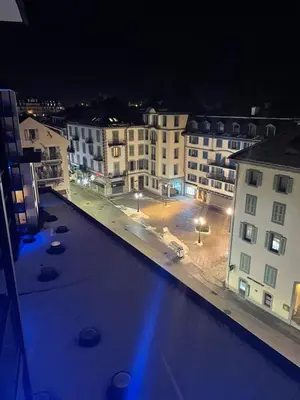 a view of a city at night with a pool at Plein centre vue panoramique exceptionnelle Sud très grand studio in Chamonix-Mont-Blanc