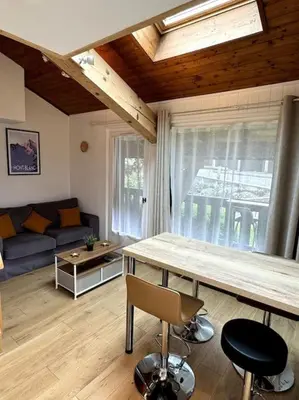 a living room with a table and a couch at Le Cozet in Saint-Gervais-les-Bains