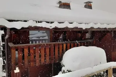a snow covered cabin with a snow covered roof at Le Cozet in Saint-Gervais-les-Bains