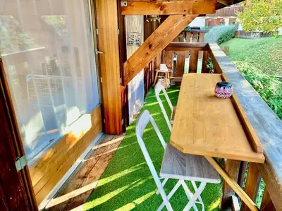 a wooden table and chairs on the porch of a house at Le Cozet in Saint-Gervais-les-Bains