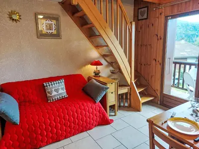 a dining room with a table and a balcony at Apartment La Coupe de Cristal-7 by Interhome in Saint-Gervais-les-Bains