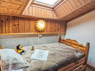 a bedroom with a bed with a television and a bed sidx sidx sidx at Apartment La Coupe de Cristal-7 by Interhome in Saint-Gervais-les-Bains