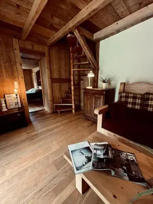 a living room with a couch and a table at La ferme de la Tour - Vallée de Chamonix in Servoz