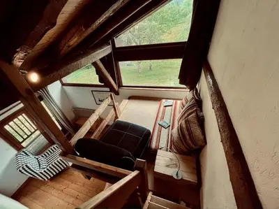 a room with a chair and a window in a cabin at La ferme de la Tour - Vallée de Chamonix in Servoz