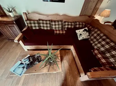 a living room with a couch and a table at La ferme de la Tour - Vallée de Chamonix in Servoz