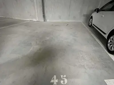a parking garage with a car parked in it at Appartement Neuf 3 Pièces avec Terrasse et Jardin, Proche Remontées Mécaniques, Parking Inclus - FR-1-597-179 in Combloux