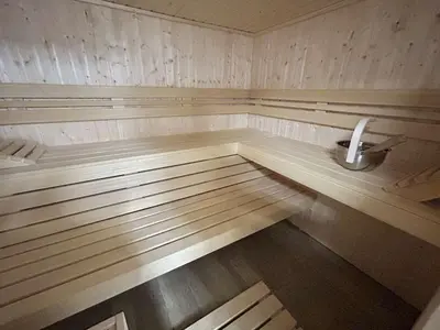 an empty sauna with wooden floors and a sink at Appartement Neuf 3 Pièces avec Terrasse et Jardin, Proche Remontées Mécaniques, Parking Inclus - FR-1-597-179 in Combloux
