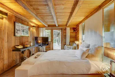 a bedroom with a large bed and a television at Mirage in Demi-Quartier