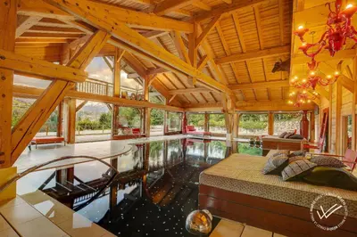 a large room with a swimming pool in a house at Mirage in Demi-Quartier