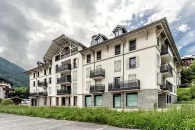 an apartment building with balconies and a parking lot at Alpina 108 départ ski & rando depuis le Bettex in Saint-Gervais-les-Bains