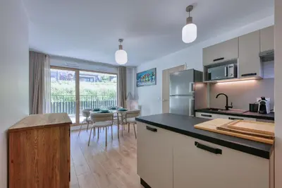 a kitchen with a counter top and a dining room at Alpina 108 départ ski & rando depuis le Bettex in Saint-Gervais-les-Bains