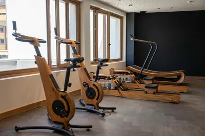 a row of exercise bikes in a room with windows at L'Eclat des Veriaz - Megève Appartement 2 chambres, Résidence de standing in Megève
