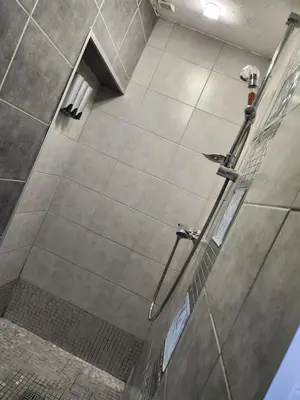 a shower in a bathroom with a glass door at Adret1 in Passy
