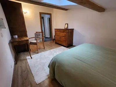 a bedroom with a bed and a desk and a dresser at Adret1 in Passy