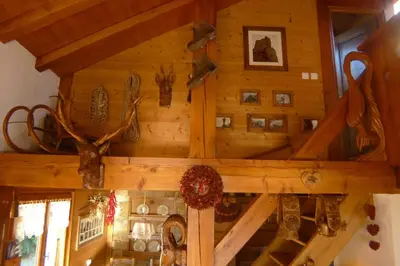 a room with a wooden wall with antlers on it at Location de charme 4 étoiles à Passy in Passy