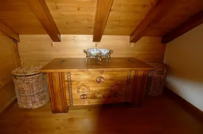 a small wooden table in a room with wooden walls at Location de charme 4 étoiles à Passy in Passy