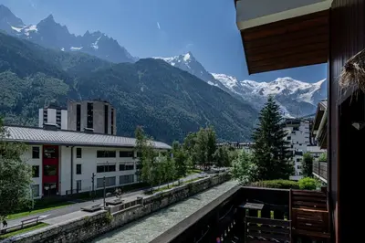 a view from a balcony of a city with mountains at Balcon de l'Arve - Charming Duplex in Chamonix Centre in Chamonix-Mont-Blanc