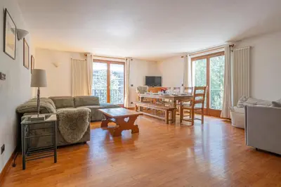 a living room with a couch and a table at Coeur des Alpes - A spacious 3-bedroom apartment with spectacular views in Chamonix-Mont-Blanc