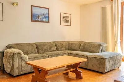 a living room with a couch and a coffee table at Coeur des Alpes - A spacious 3-bedroom apartment with spectacular views in Chamonix-Mont-Blanc