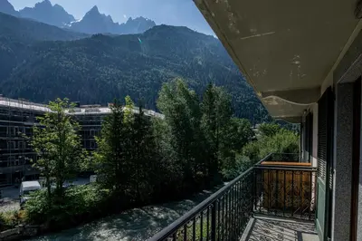 a balcony of a building with a view of mountains at Coeur des Alpes - A spacious 3-bedroom apartment with spectacular views in Chamonix-Mont-Blanc