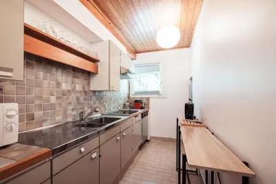 a small kitchen with a sink and a counter at Appartement l'Olympique - Ski in & ski out in Megève