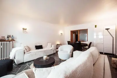 a living room with two couches and a table at Appartement l'Olympique - Ski in & ski out in Megève