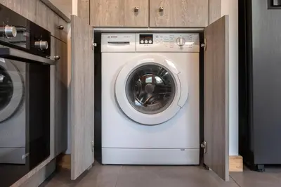 a white washer and dryer in a kitchen at Les Trabets - Bellevue telecabine - Renove in Les Houches