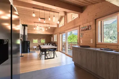 a kitchen and dining room with a table with chairs at Les Trabets - Bellevue telecabine - Renove in Les Houches