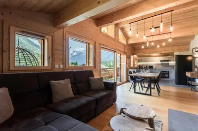 a living room with a couch and a table at Les Trabets - Bellevue telecabine - Renove in Les Houches