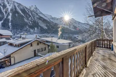 a view from a balcony with snow covered mountains at Apt 8 pers hyper centre à Chamonix in Chamonix-Mont-Blanc